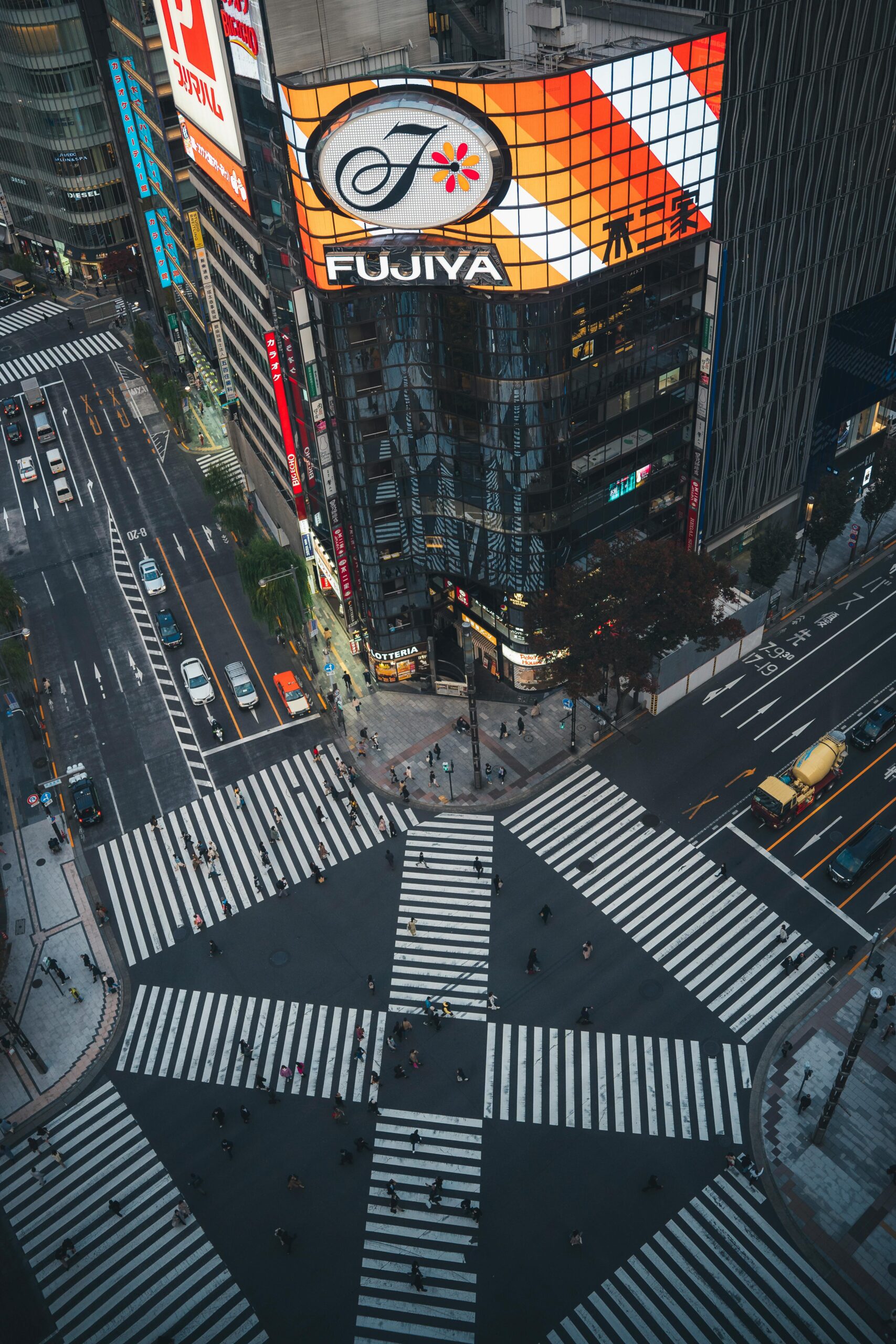 High angle view of bustling Shibuya Crossing in Tokyo with vibrant signage and busy streets.