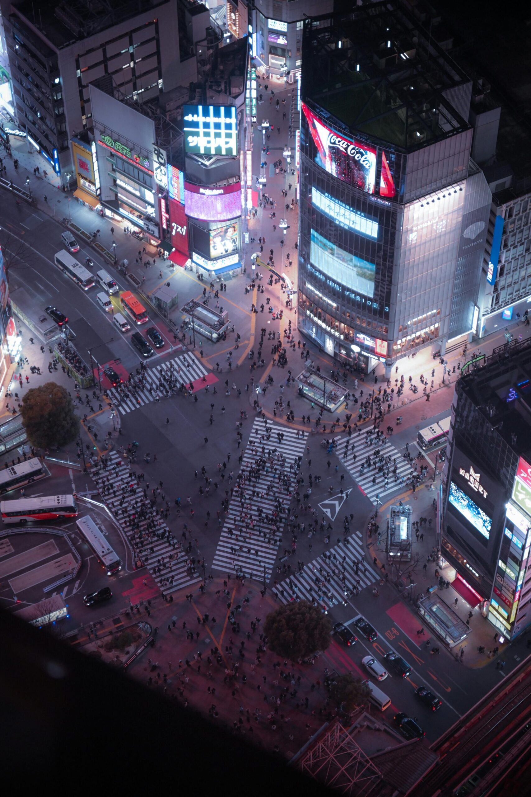 Aerial view of bustling Shibuya Crossing at night in Tokyo, Japan.