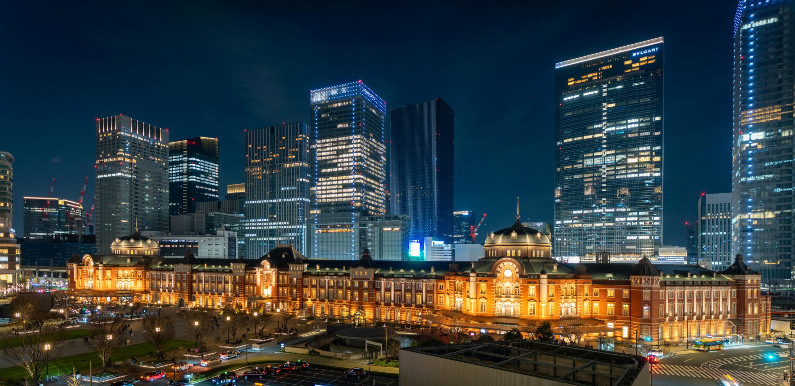 Stunning night view of Tokyo Station with towering skyscrapers in Chiyoda City, Tokyo.